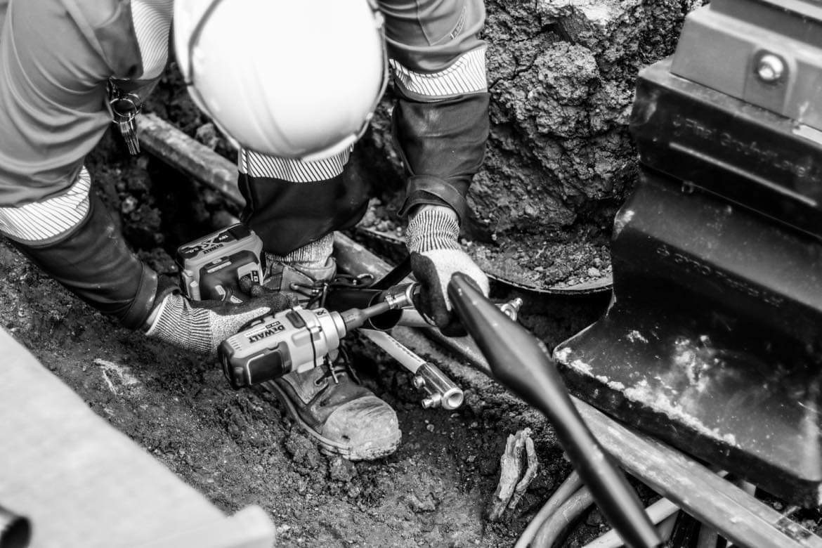 Cable jointing work being carried out in a trench