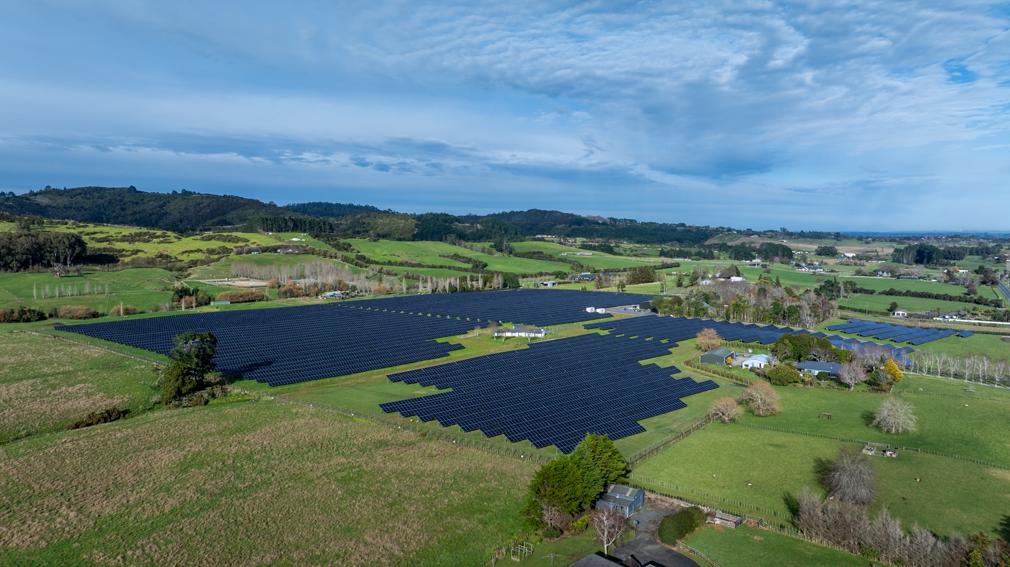 Aerial view of the solar panel arrays and surrounding farmland at Ardmore Solar Farm